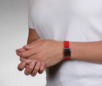Flex Medical ID Bracelet Red with red and white logo on a stainless steel emblem  on wrist