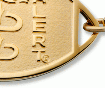 Close-up of 10 karat gold classic embossed medical ID bracelet with oval emblem and logo