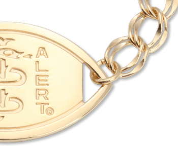 A close-up of a 14 karat gold Santa Rosa medical ID bracelet with oval MedicAlert emblem and logo