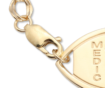 A close-up of the clasp of the 14 karat gold Santa Rosa medical ID bracelet with oval MedicAlert emblem and logo