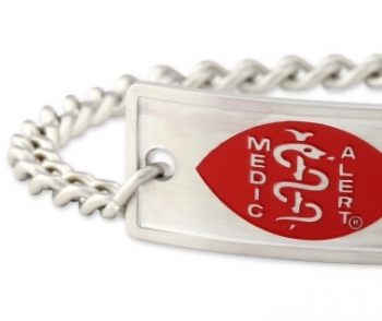 Close-up view of a medical ID bracelet with rope links, rectangle emblem in red