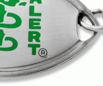 Close-up view of classic medical ID bracelet in stainless steel with green MedicAlert logo on front of oval emblem 