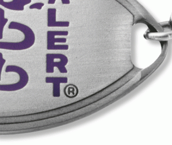 Close-up view of medical ID bracelet with oval MedicAlert emblem and logo in purple