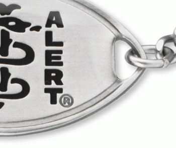 A close-up view of a medical ID bracelet with oval MedicAlert emblem and logo in black