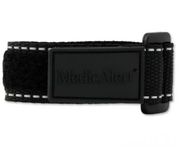 A close-up view of the black reflective medical ID bracelet with fabric band, silver square MedicAlert emblem and logo