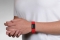 Person wearing on wrist the Performance silicone Medical ID bracelet with a red band and a black colored rectangular emblem