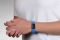 Person wearing on wrist the Performance silicone Medical ID bracelet with a blue band and a black colored rectangular emblem