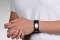 Person wearing black sport band medical ID bracelet with oval MedicAlert emblem and log
